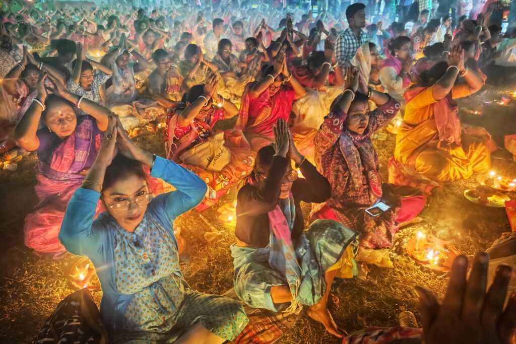 Crowd of people praying with hands together